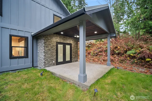 a view of yellow house with a yard potted plants
