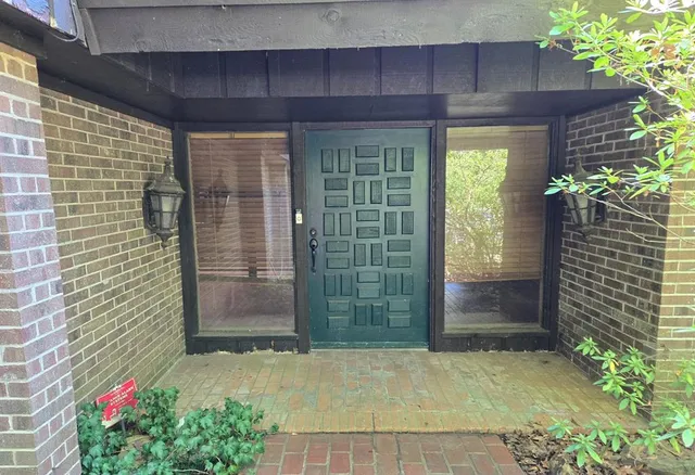 a view of a brick house with a potted plant