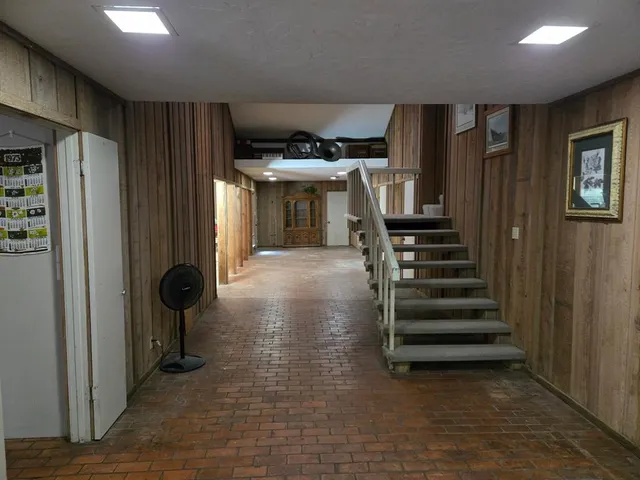 a view of a hallway with entryway and furniture