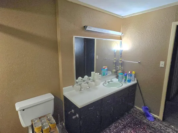 a bathroom with a sink mirror and a shower