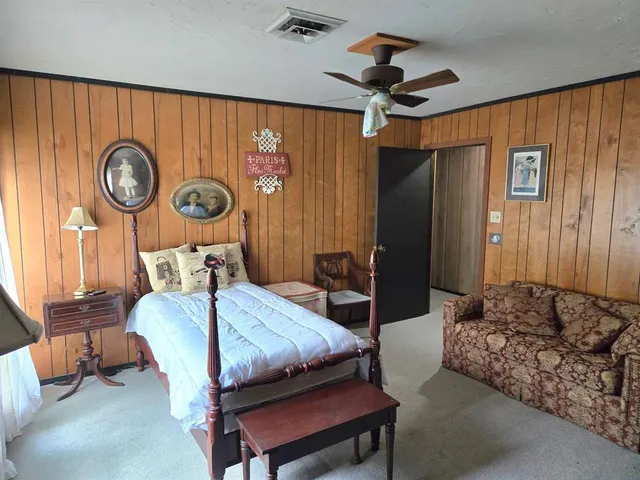 a bedroom with furniture and a mirror