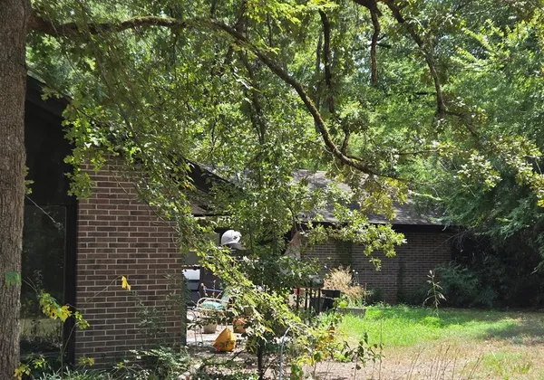 a backyard of a house with lots of green space and garden