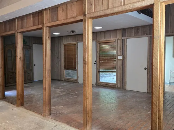 a living room with stainless steel appliances kitchen island a flat screen tv and a refrigerator
