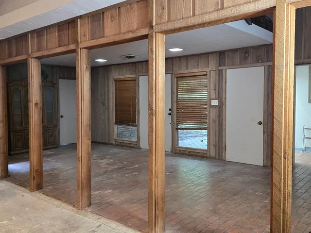a living room with stainless steel appliances kitchen island a flat screen tv and a refrigerator