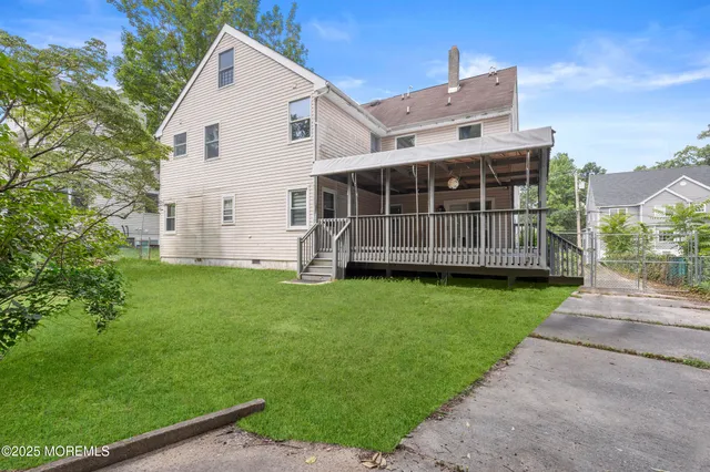 a view of house with backyard