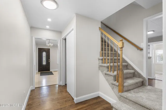 a view of entryway and hall with wooden floor