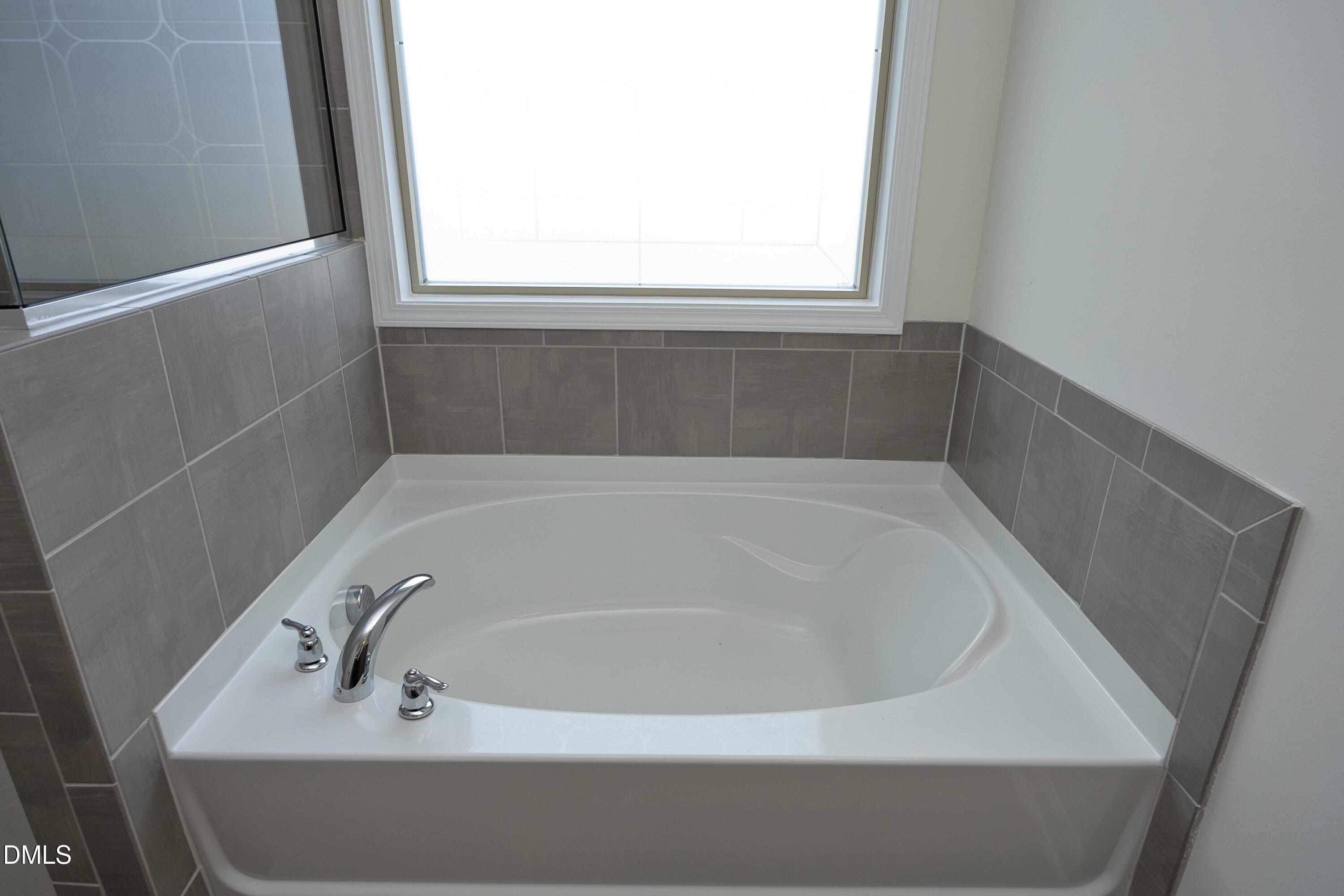 824 Country Downs Road Wake Forest, NC 27587 - Photo 23 of 41 a bathroom with a bathtub