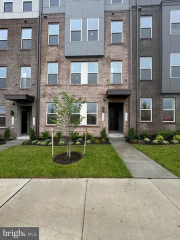 a view of a brick building next to a yard