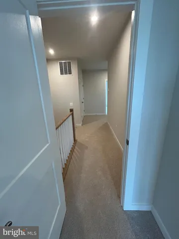 a view of a hallway with staircase