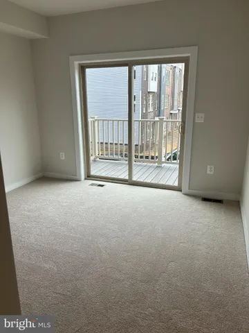 a view of an empty room with a balcony
