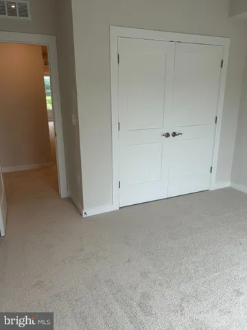 a view of a hallway to rooms