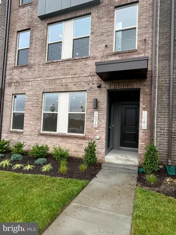 a front view of a house with a garden and plants