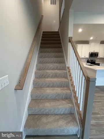 a view of a livingroom with furniture and stairs