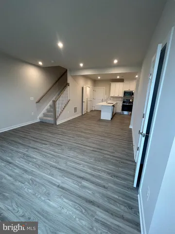 a kitchen with stainless steel appliances granite countertop a stove and a refrigerator