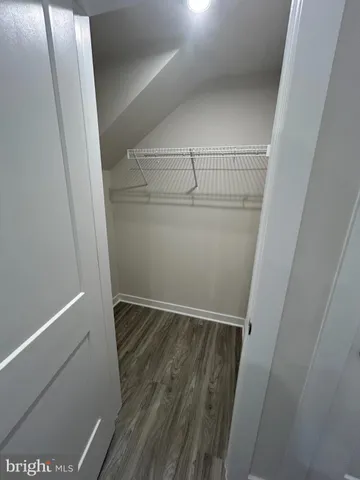 a view of kitchen and hall with wooden floor