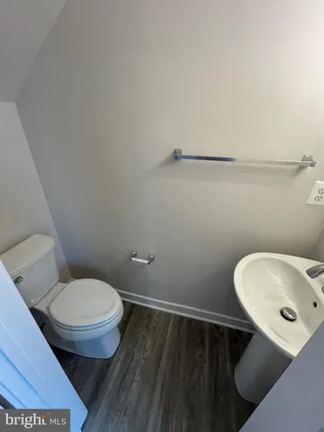 a large hall with wooden floor and windows