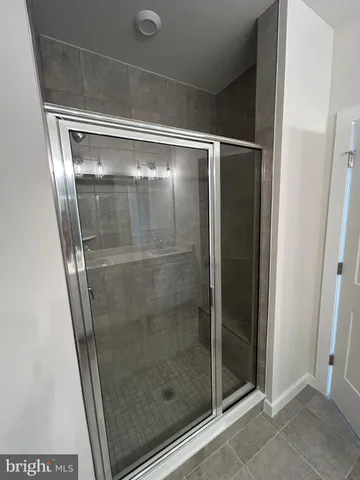 a bathroom with a glass shower door