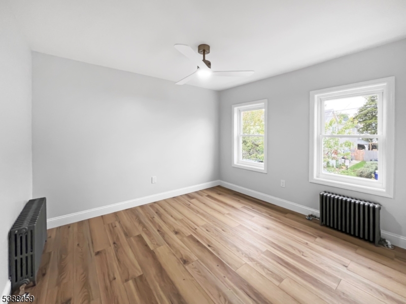 86 Heckman Street Phillipsburg, NJ 08865 - Photo 15 of 24 a view of an empty room with wooden floor and a window