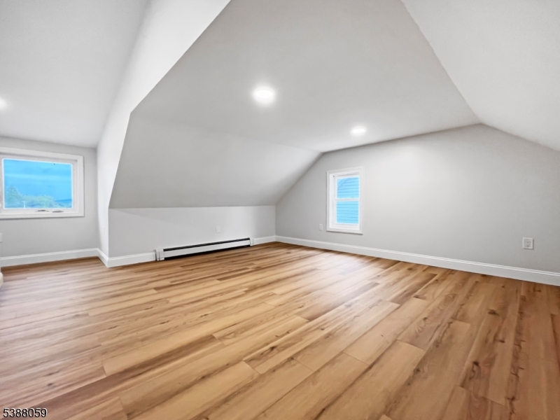 86 Heckman Street Phillipsburg, NJ 08865 - Photo 19 of 24 an empty room with wooden floor and windows