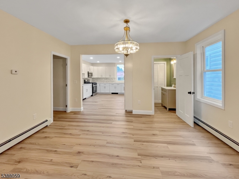 86 Heckman Street Phillipsburg, NJ 08865 - Photo 5 of 24 a view of a hallway with wooden floor and a kitchen
