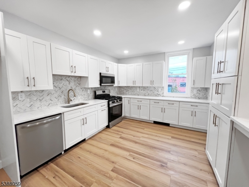 86 Heckman Street Phillipsburg, NJ 08865 - Photo 6 of 24 a kitchen with white cabinets stainless steel appliances and sink