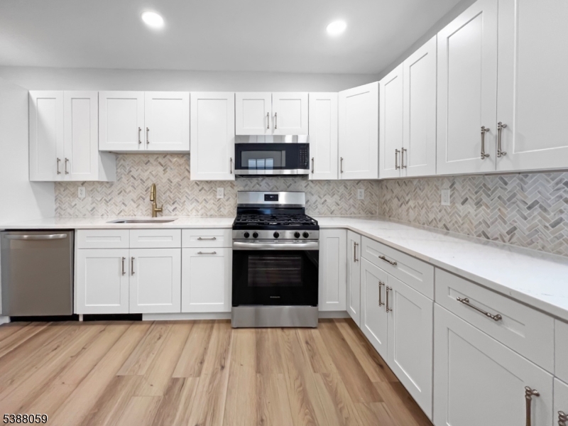 86 Heckman Street Phillipsburg, NJ 08865 - Photo 8 of 24 a kitchen with granite countertop white cabinets and stainless steel appliances