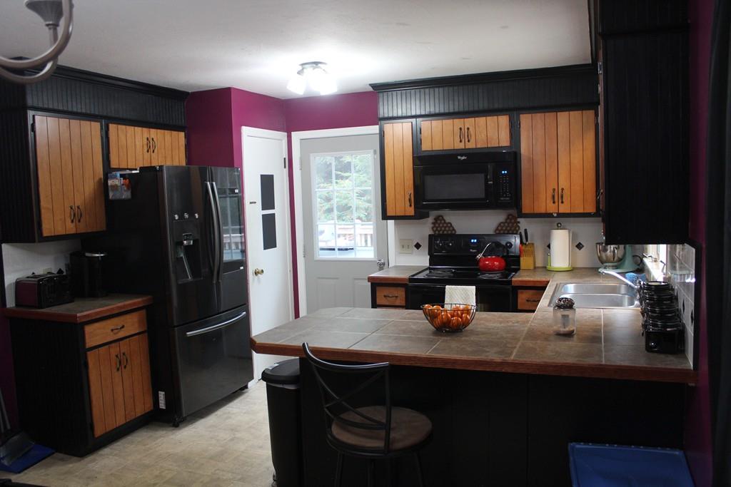 58 Corey Hill Road Ashburnham, MA 01430 - Photo 4 of 13 a kitchen with a sink refrigerator and cabinets