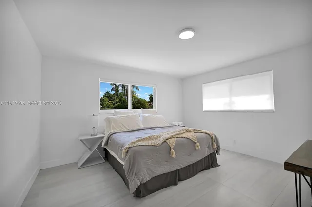 a bedroom with a bed and window