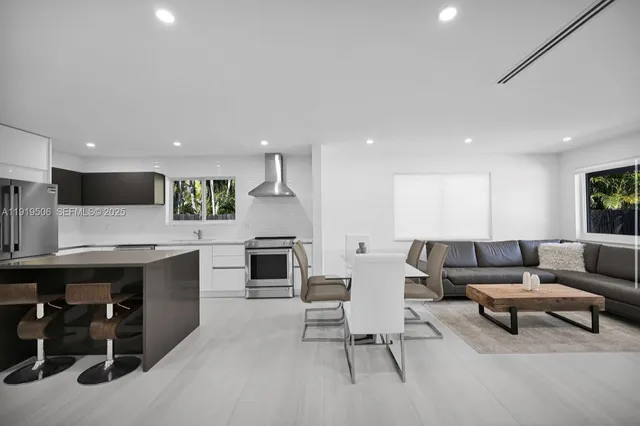 a living room with furniture and kitchen view