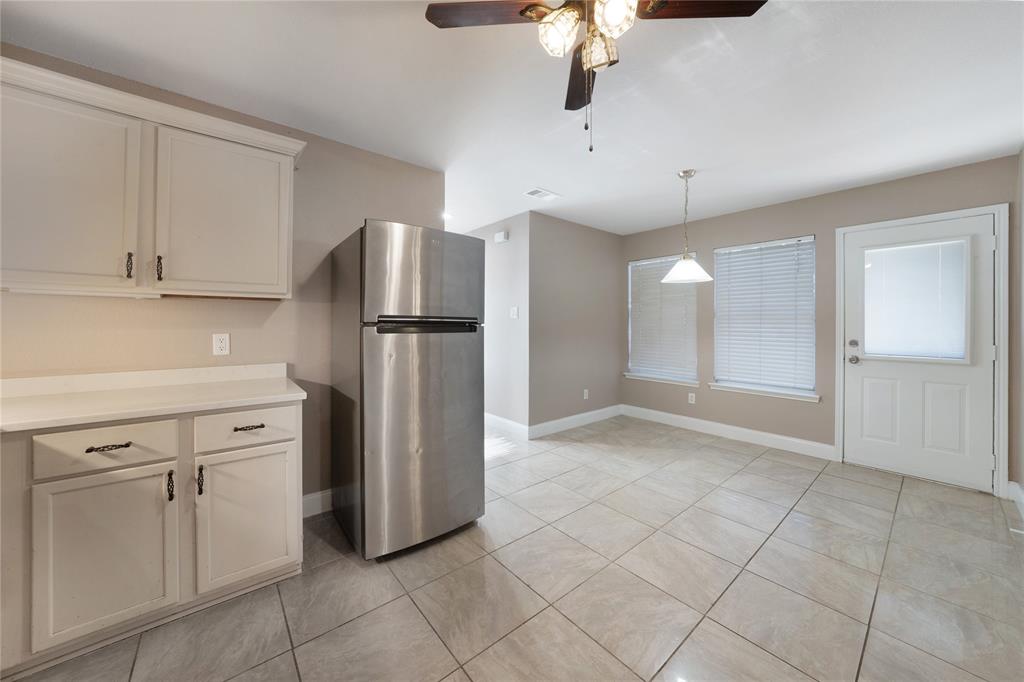 13241 Ridgepointe Road Fort Worth, TX 76244 - Photo 11 of 31 a kitchen with white cabinets and refrigerator