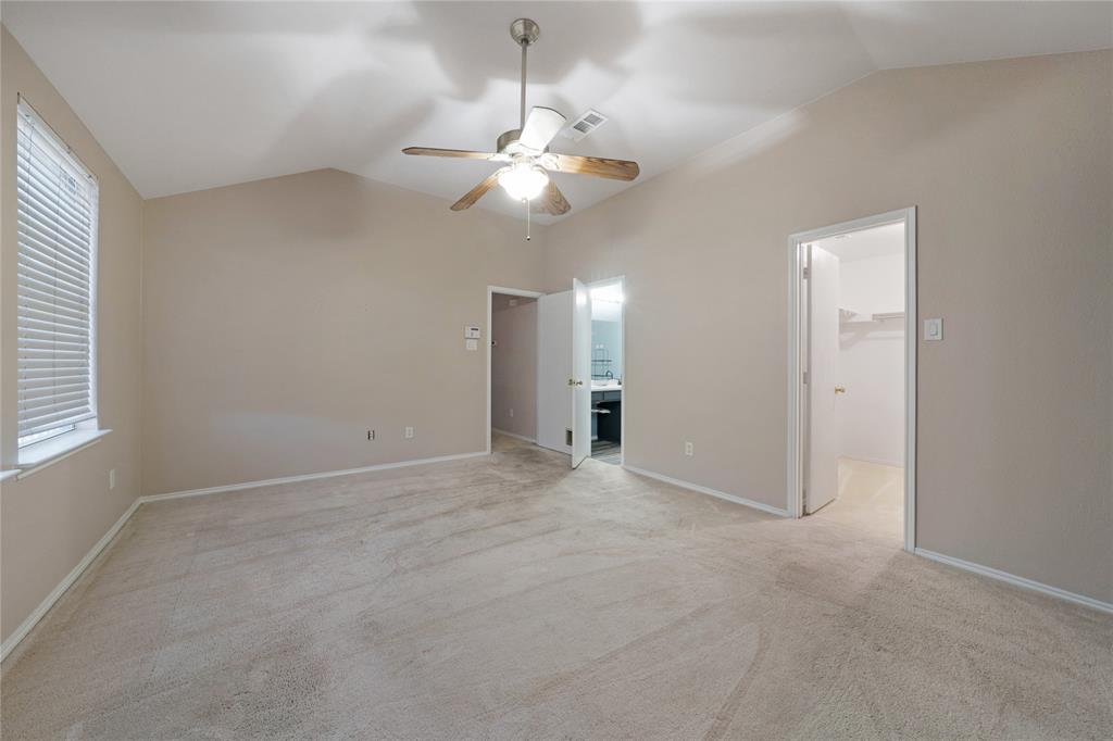 13241 Ridgepointe Road Fort Worth, TX 76244 - Photo 21 of 31 an empty room with chandelier fan and windows