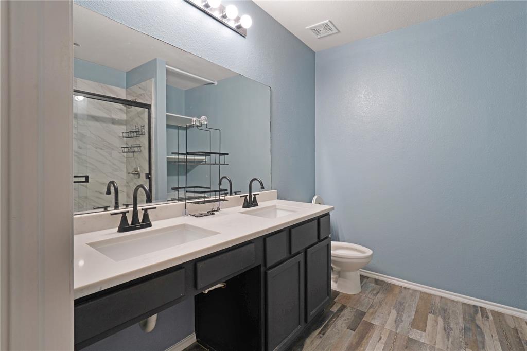 13241 Ridgepointe Road Fort Worth, TX 76244 - Photo 22 of 31 a bathroom with a sink a toilet and mirror