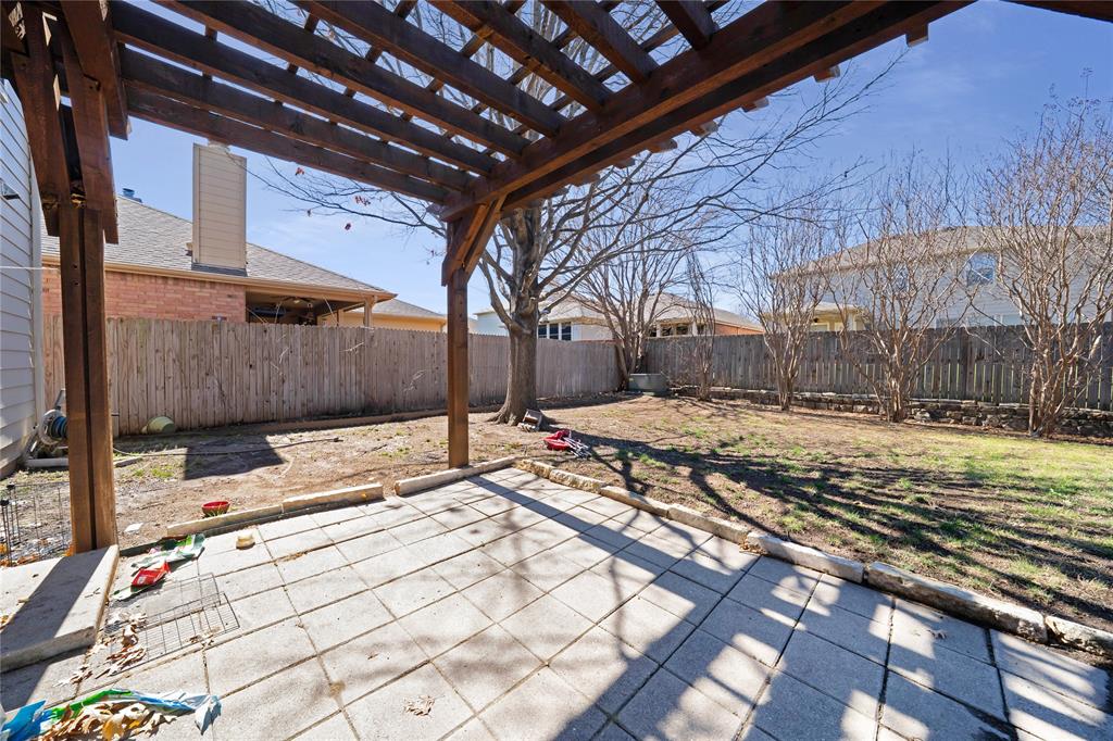 13241 Ridgepointe Road Fort Worth, TX 76244 - Photo 25 of 31 a view of a backyard with a table and chairs