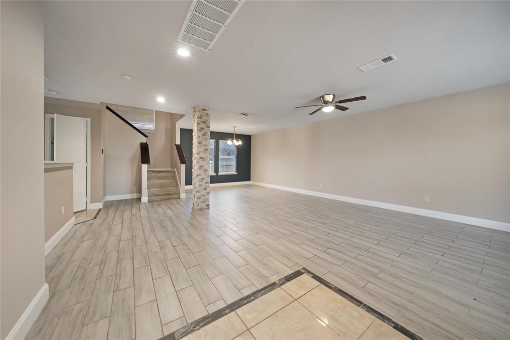 13241 Ridgepointe Road Fort Worth, TX 76244 - Photo 3 of 31 wooden floor in an empty room with a window