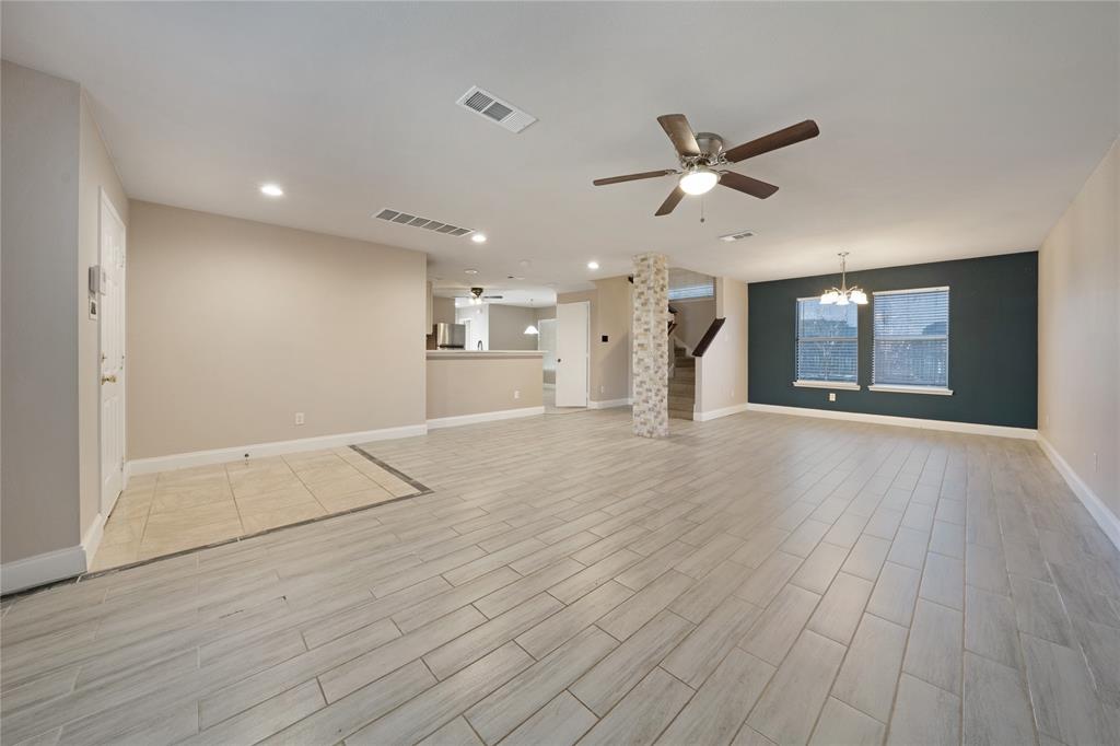 13241 Ridgepointe Road Fort Worth, TX 76244 - Photo 4 of 31 a view of an empty room with wooden floor and a ceiling fan