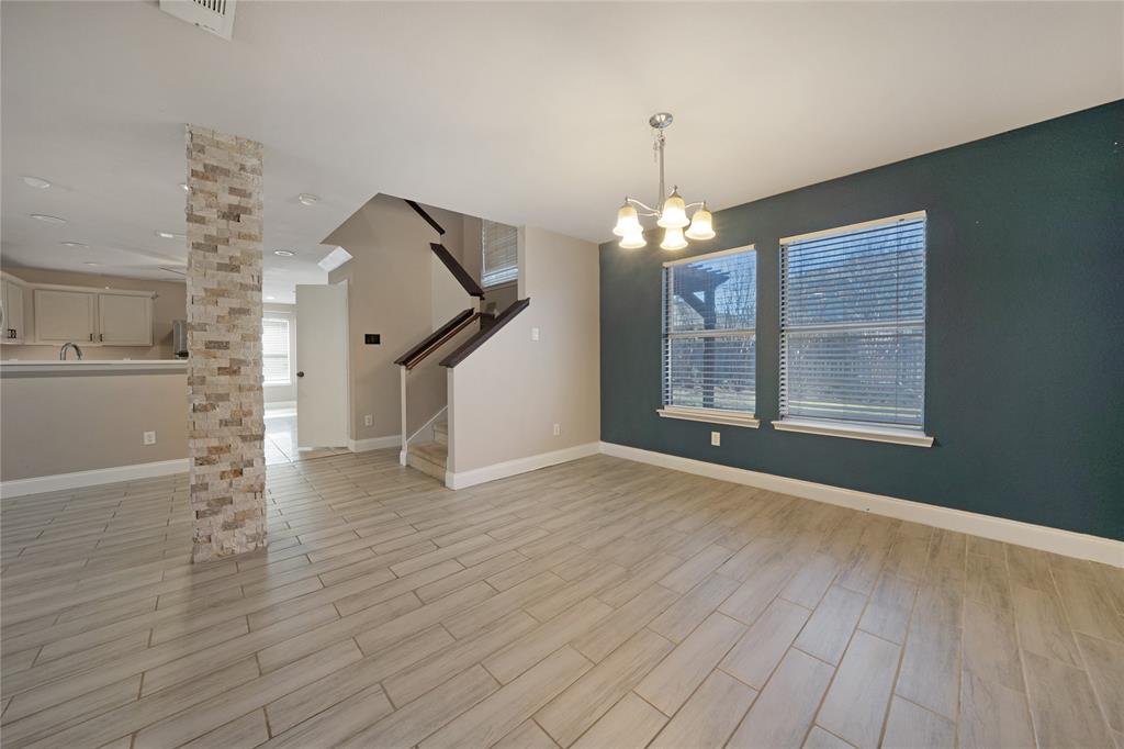 13241 Ridgepointe Road Fort Worth, TX 76244 - Photo 5 of 31 a view of an empty room with wooden floor and a window