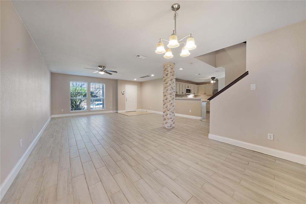 13241 Ridgepointe Road Fort Worth, TX 76244 - Photo 6 of 31 a view of an empty room with wooden floor and a window