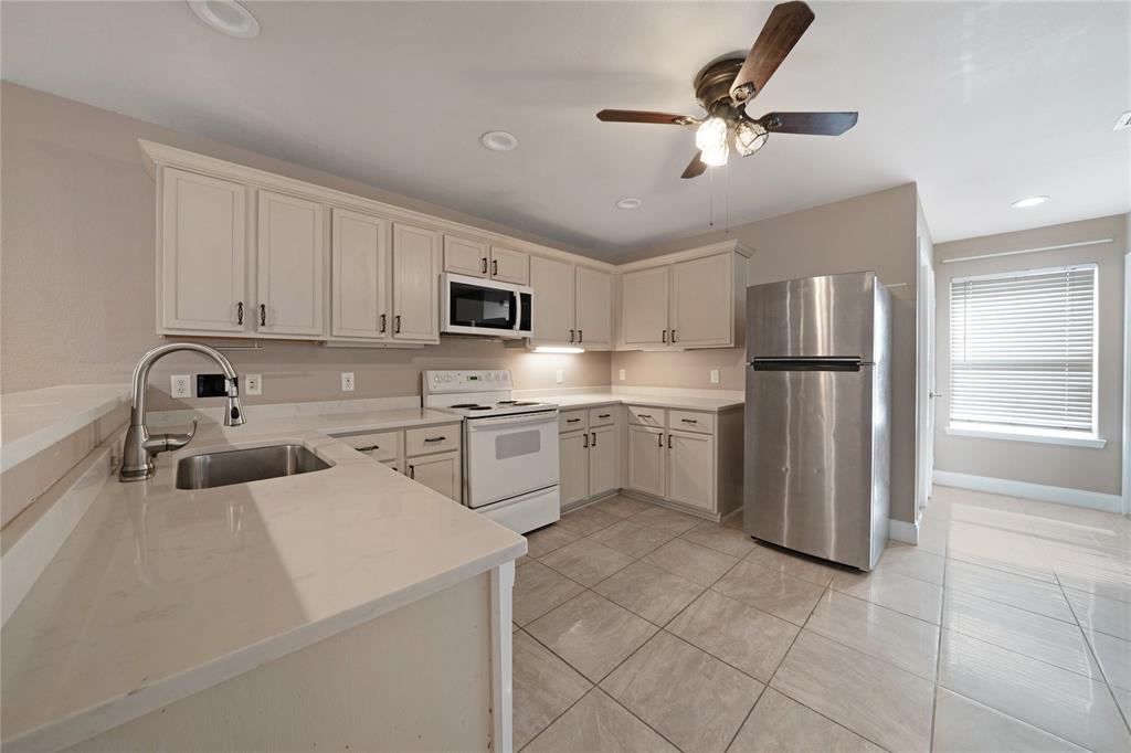 13241 Ridgepointe Road Fort Worth, TX 76244 - Photo 8 of 31 a kitchen with cabinets stainless steel appliances and a window