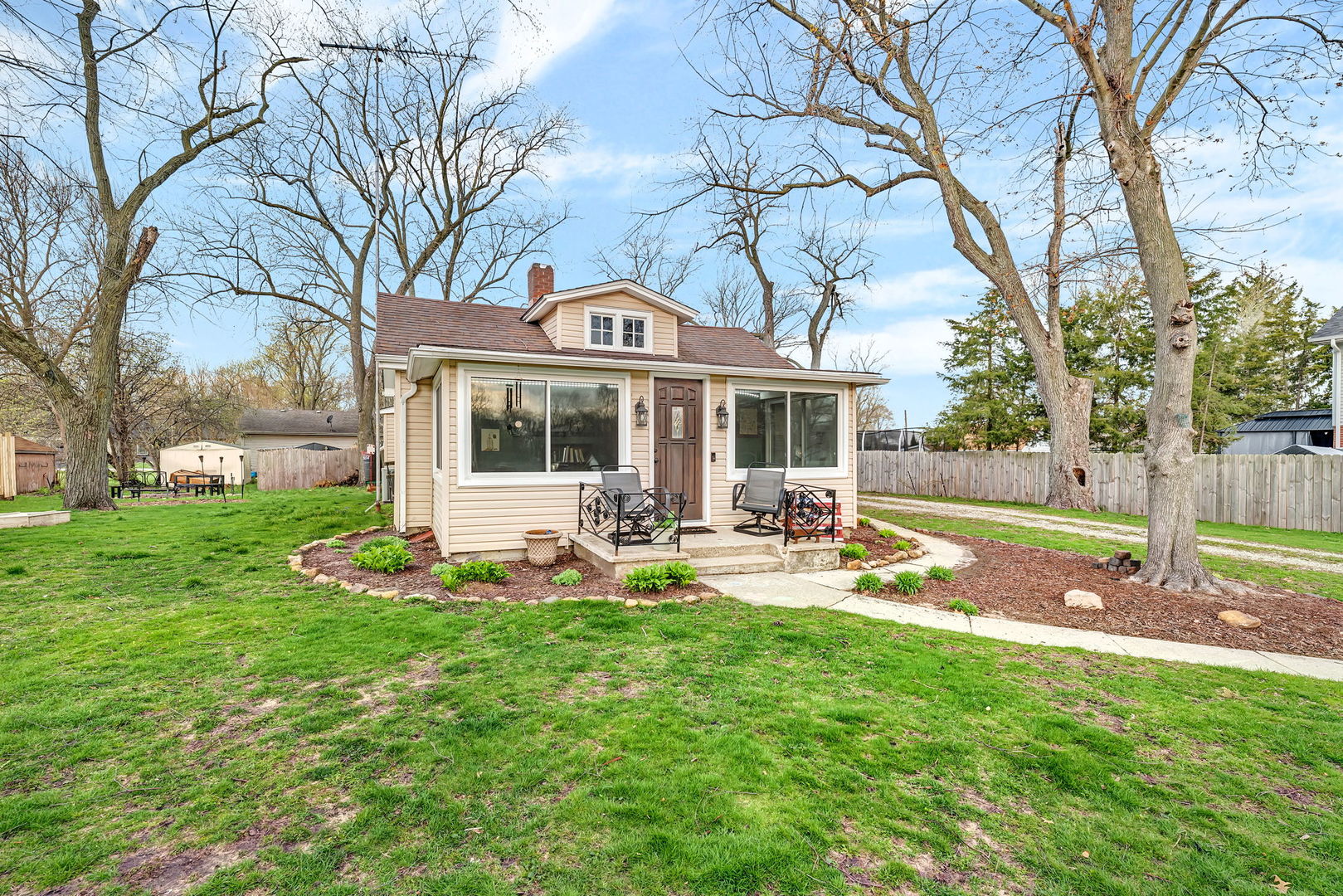 136 Grove Street Braidwood, IL 60408 - Photo 2 of 26 a front view of a house with backyard area and tree