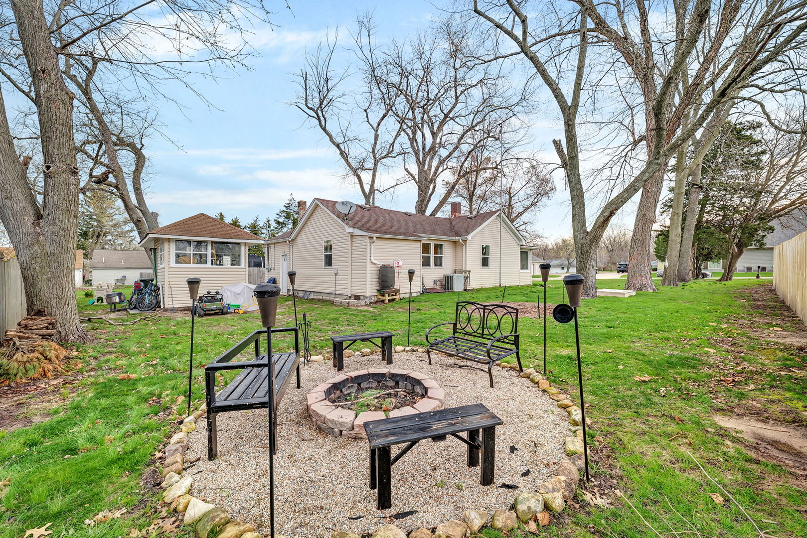 136 Grove Street Braidwood, IL 60408 - Photo 22 of 26 a view of a white house with a yard table and chairs