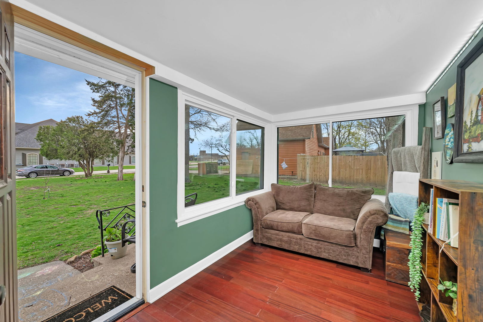 136 Grove Street Braidwood, IL 60408 - Photo 4 of 26 a living room with couch floor to ceiling window and wooden floor