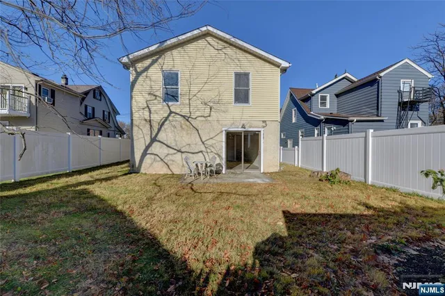 a view of a house with a backyard