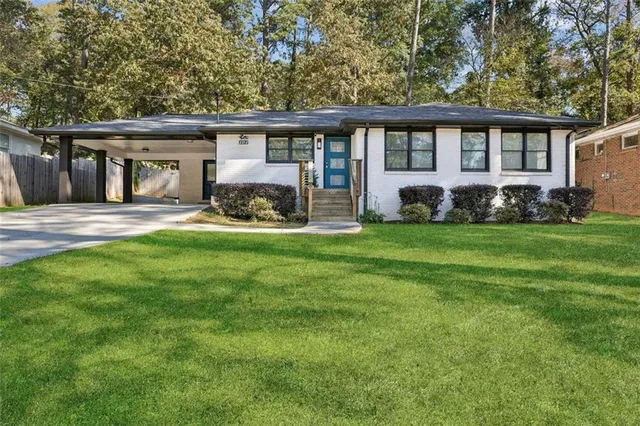 a front view of a house with a yard and porch