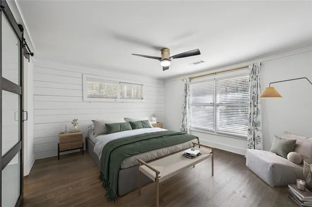 a bedroom with furniture and a large window