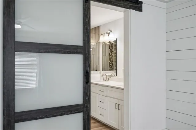 a view of bathroom with a sink and mirror