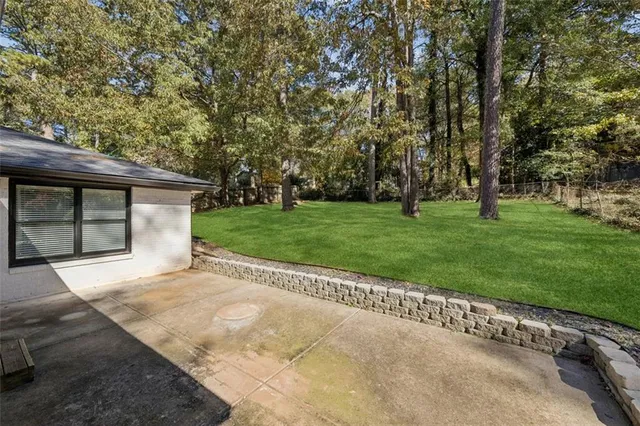 a view of a house with a backyard