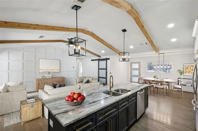 a kitchen with granite countertop a table and chairs in it