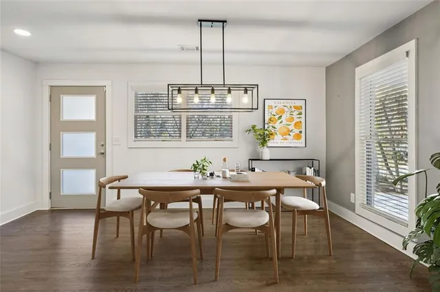 a view of a dining room with furniture wooden floor and a chandelier