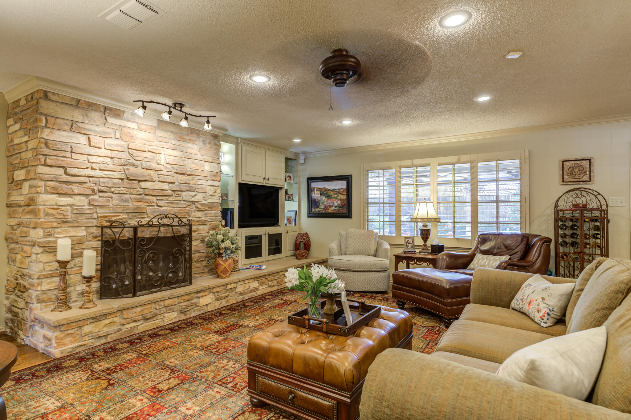 3614 68th Street Lubbock, TX 79413 - Photo 14 of 68 a living room with furniture a fireplace and a flat screen tv