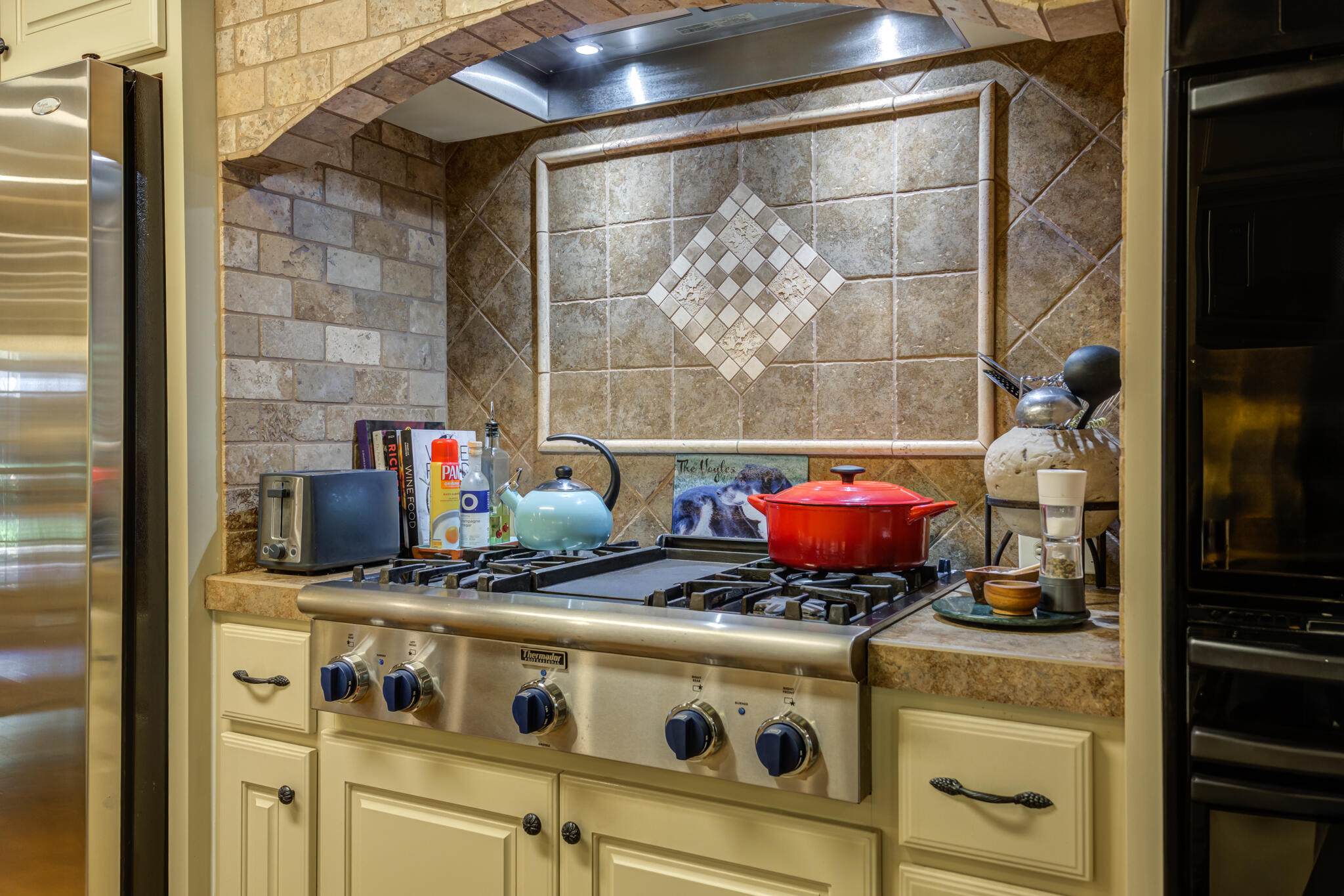3614 68th Street Lubbock, TX 79413 - Photo 26 of 68 a table with a stove and white cabinets